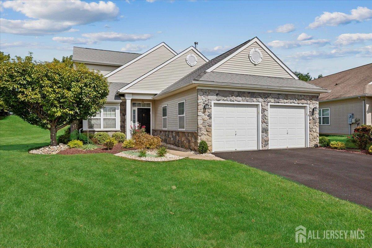 a front view of a house with a yard and garage