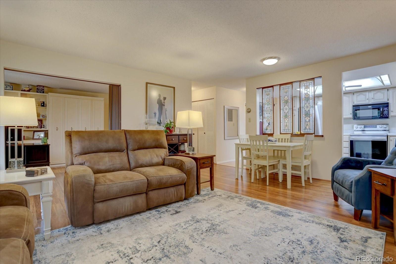 a living room with furniture a fireplace and a table