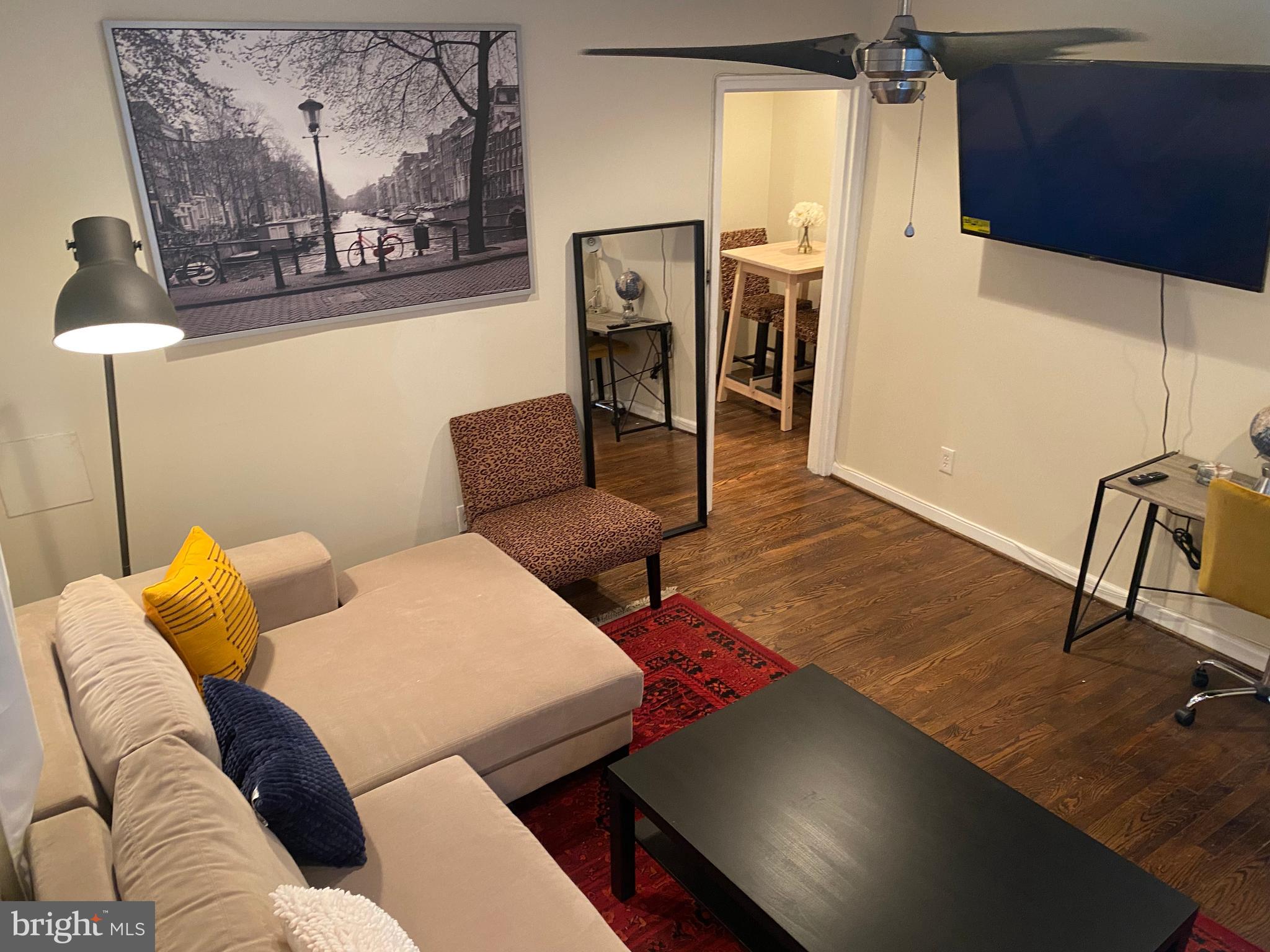 a living room with furniture and a flat screen tv