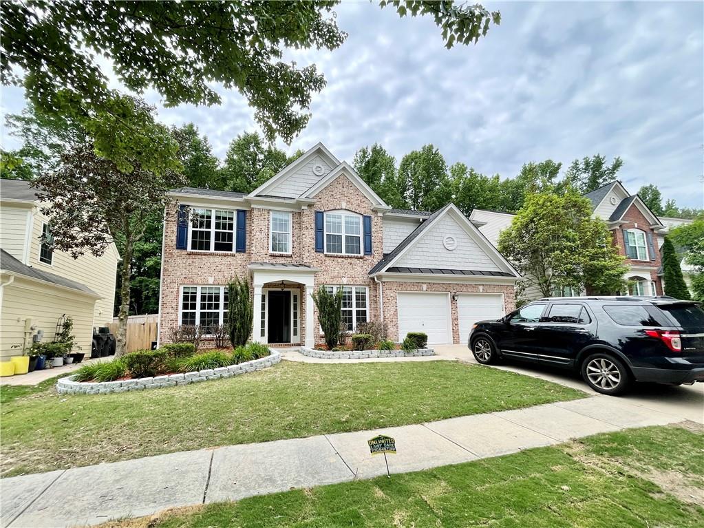 a front view of a house with a yard