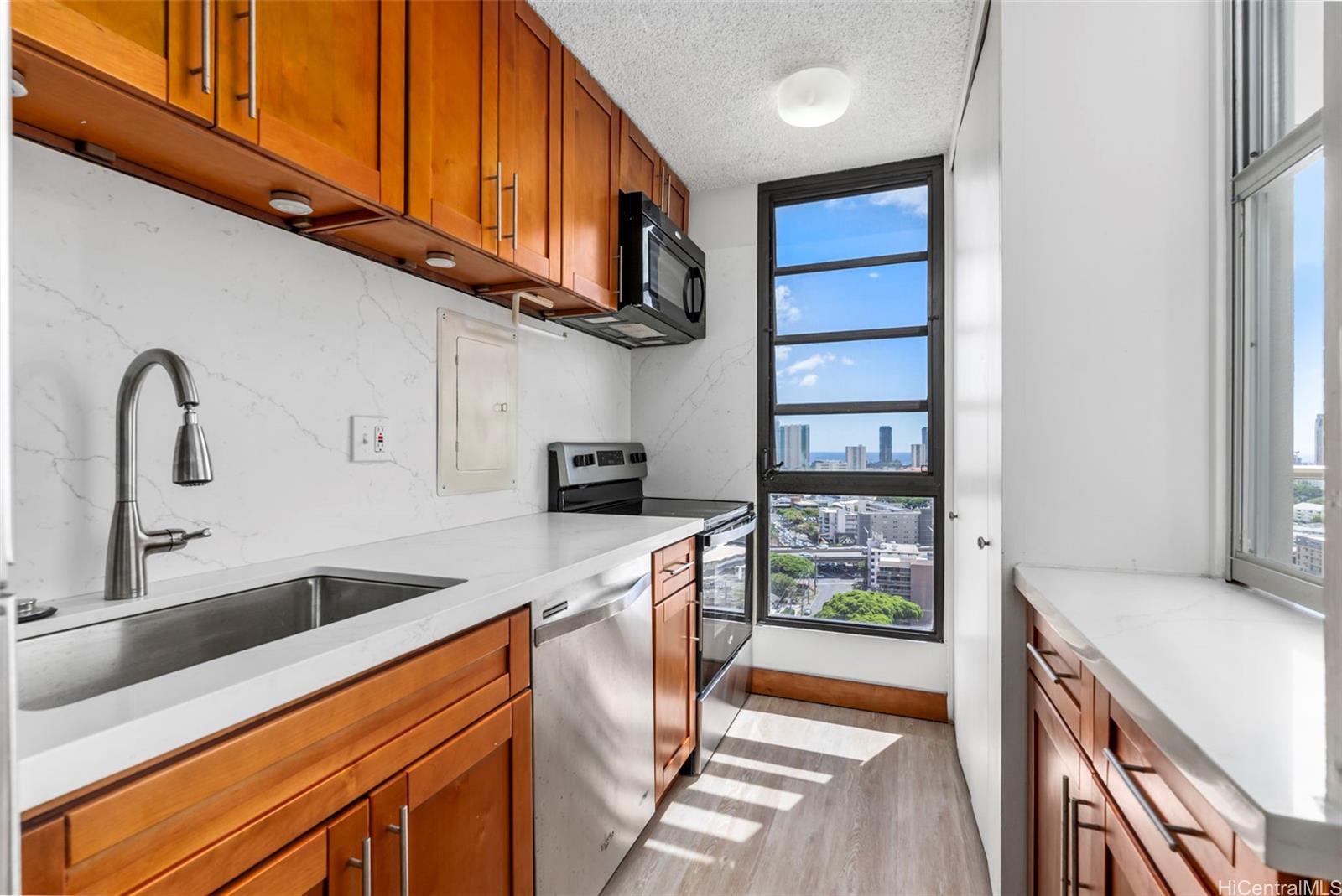 a kitchen with stainless steel appliances granite countertop a sink and cabinets