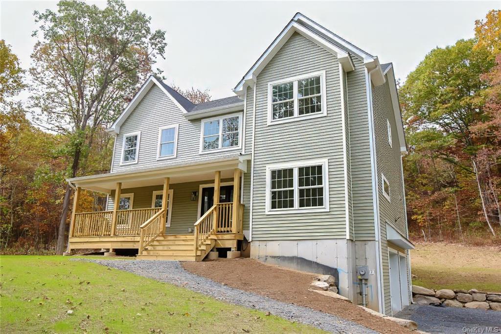 a view of a house with a yard and large windows