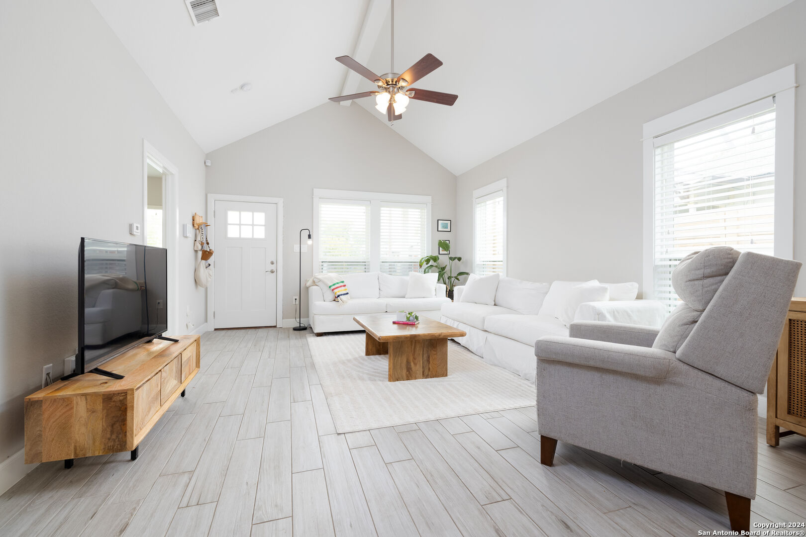 a living room with furniture and a flat screen tv