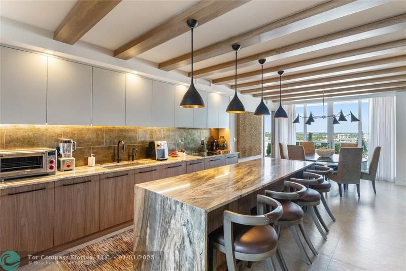 a kitchen with a table and chairs