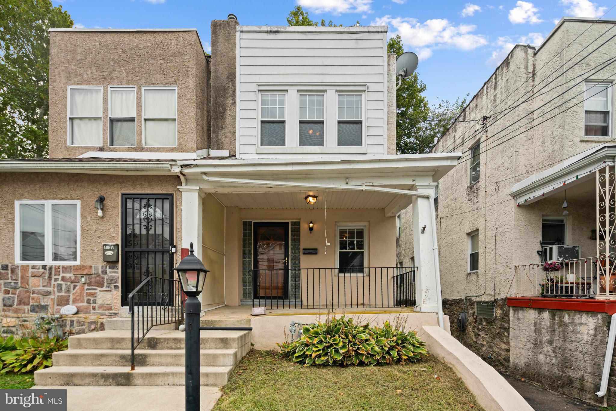 front view of a brick house with a yard