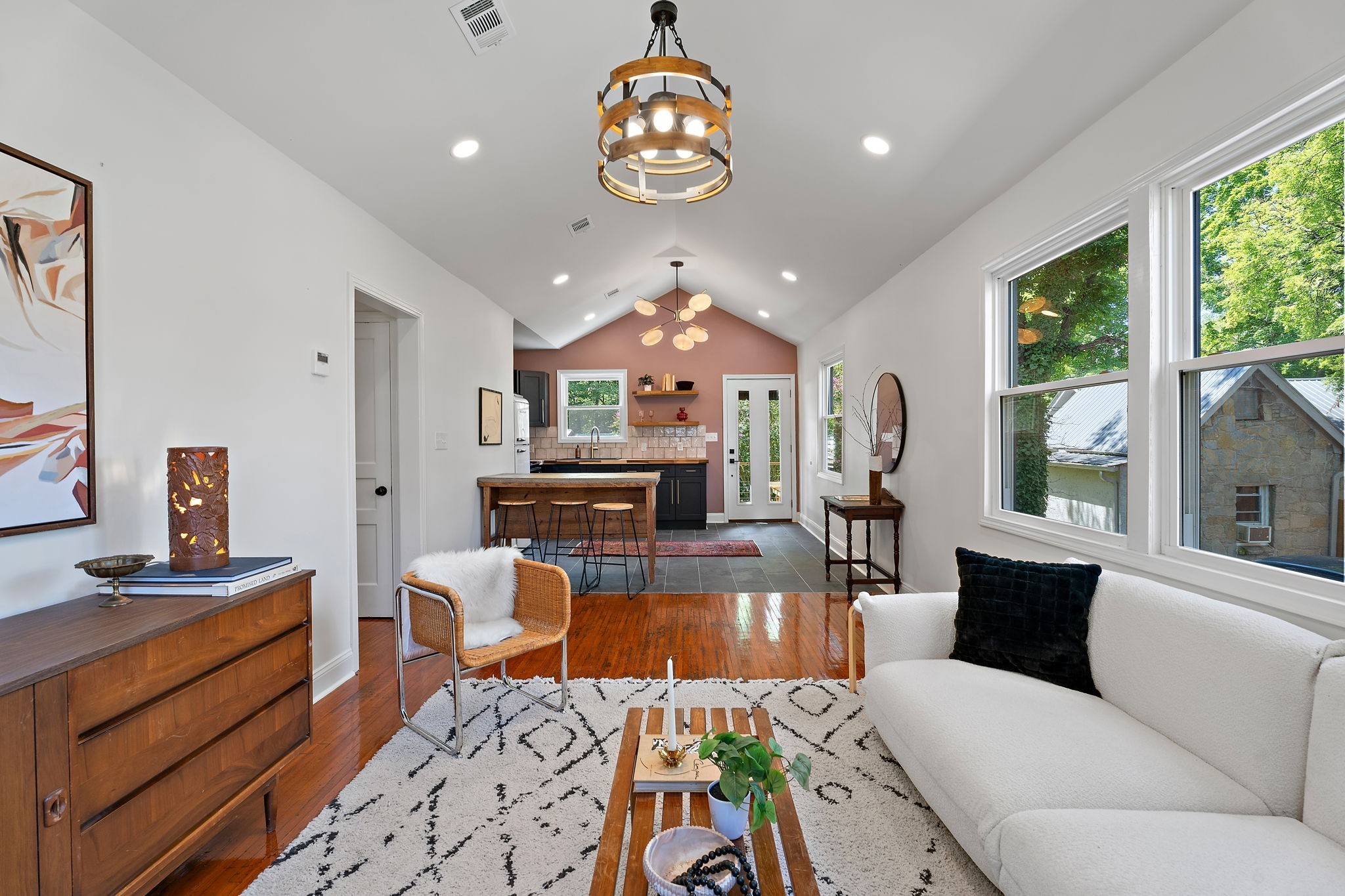 a living room with furniture a fireplace and a chandelier