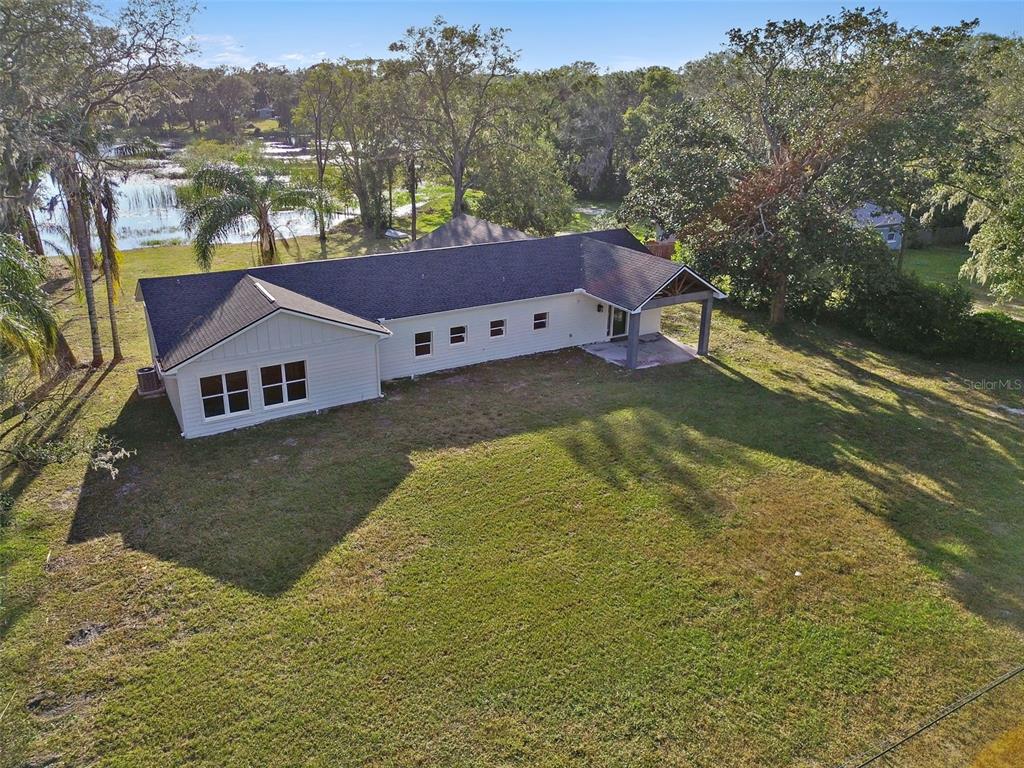 a view of house with a yard