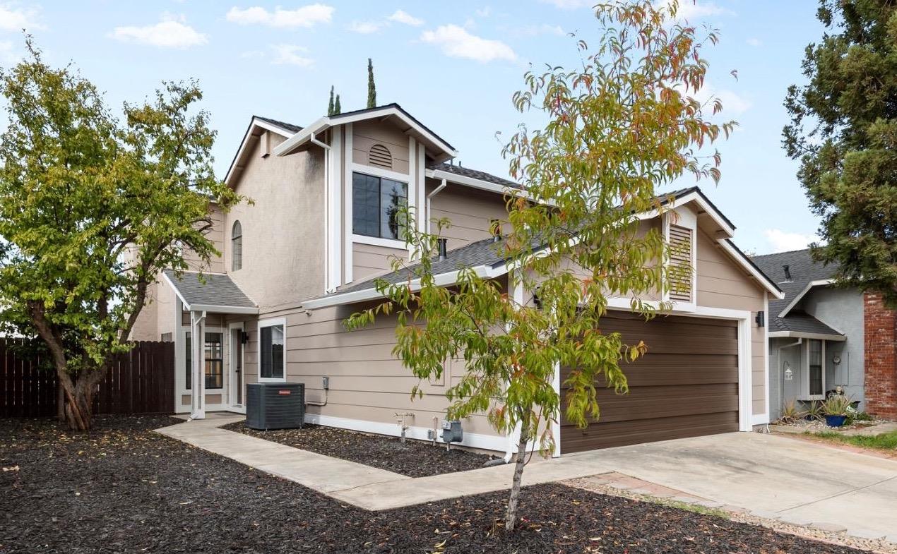 a view of a house with a tree in the background