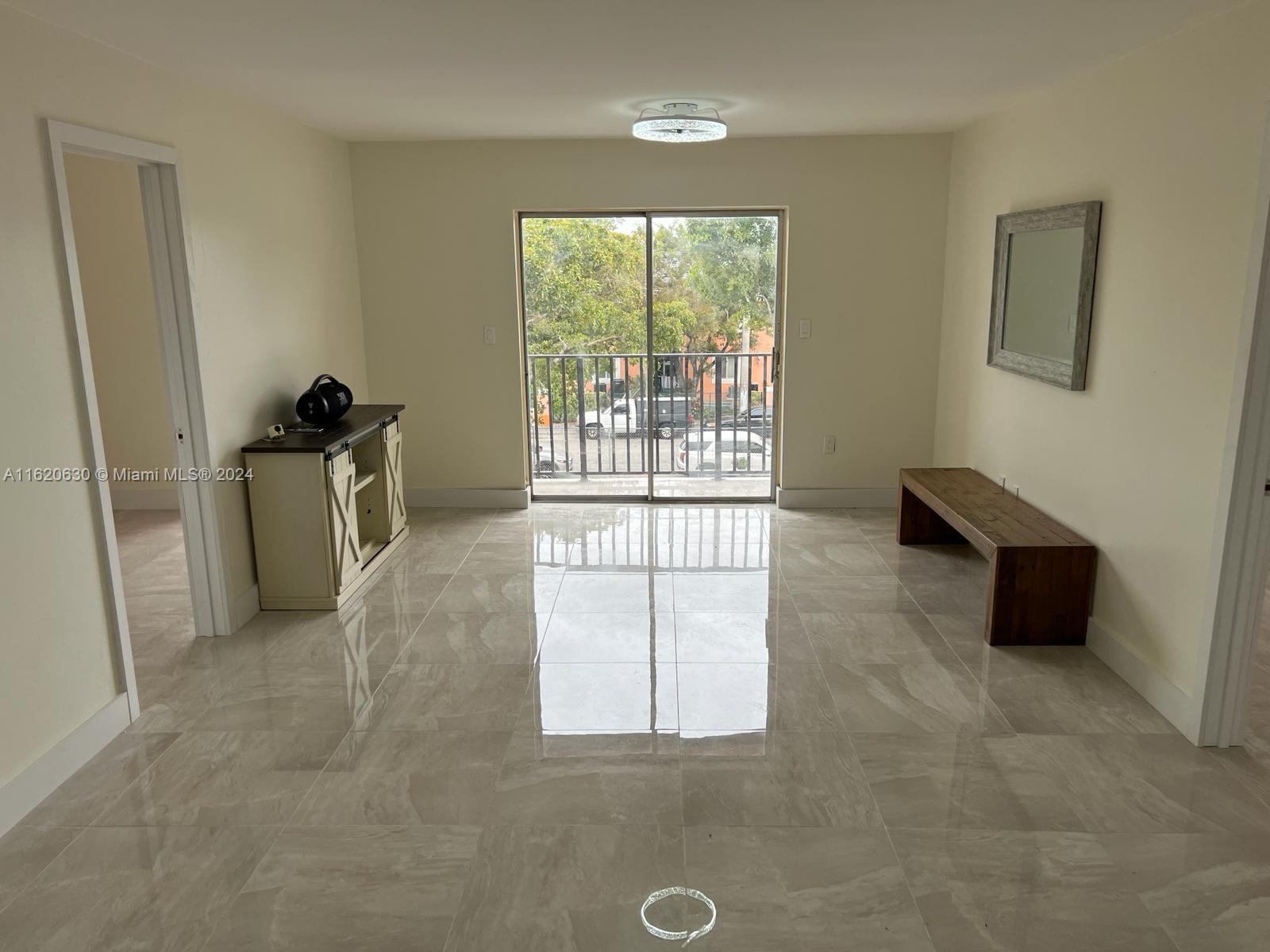 a living room with furniture a flat screen tv and a large window