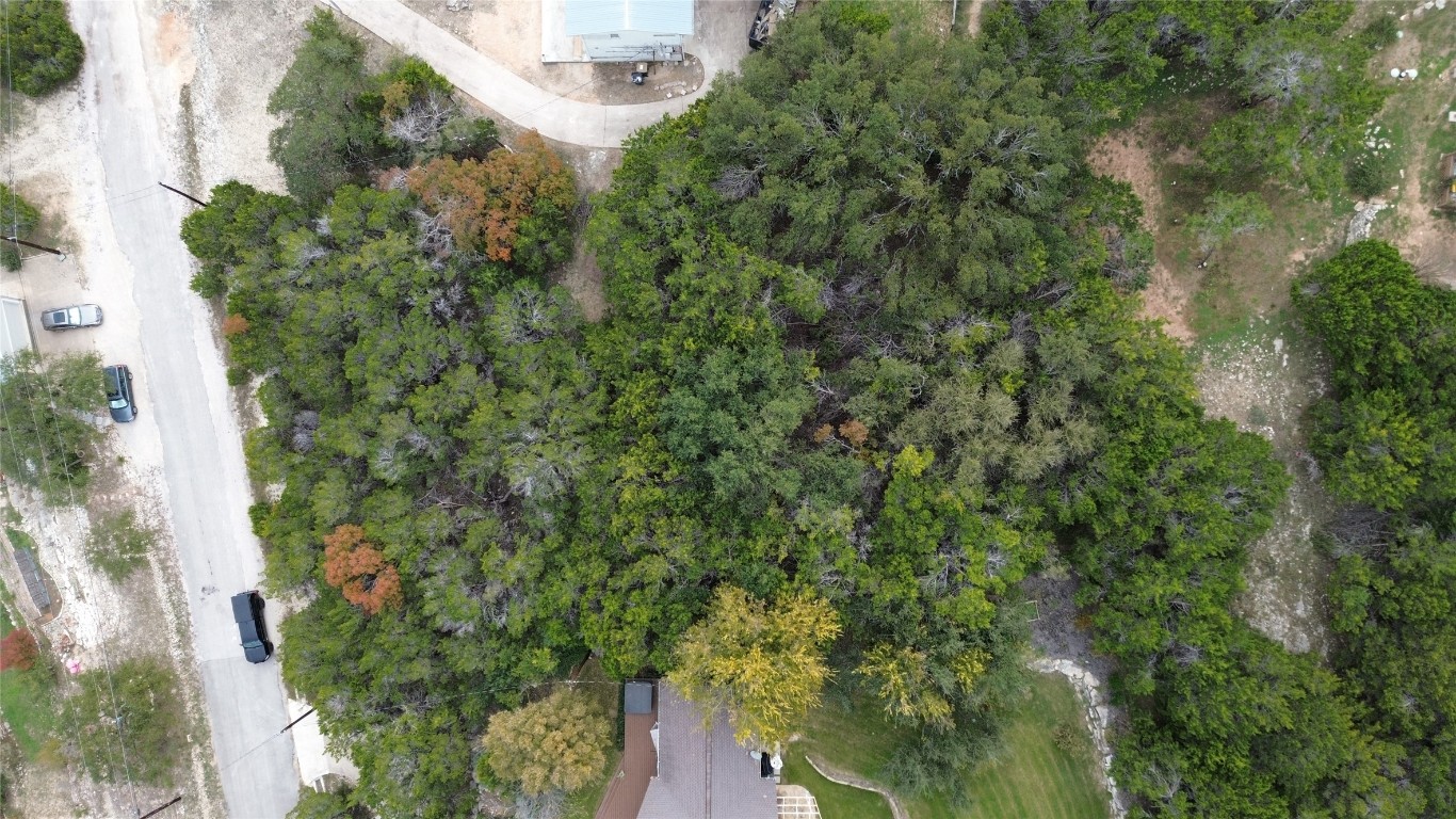 an aerial view of a houses with yard