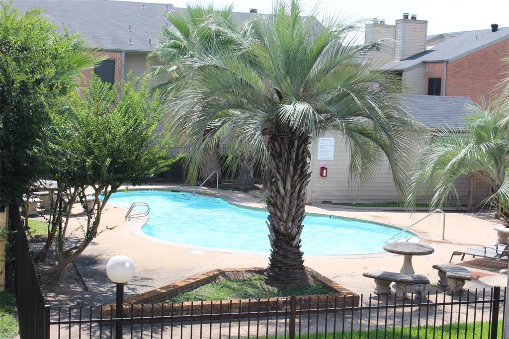 a view of a yard in front of a house with a fountain