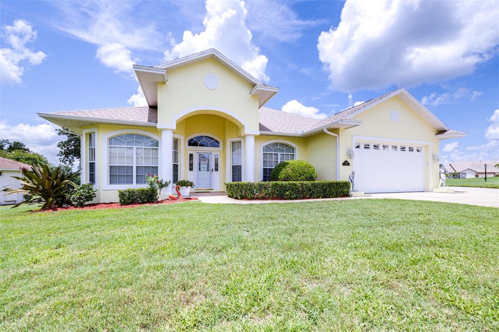 a front view of house with yard and outdoor seating