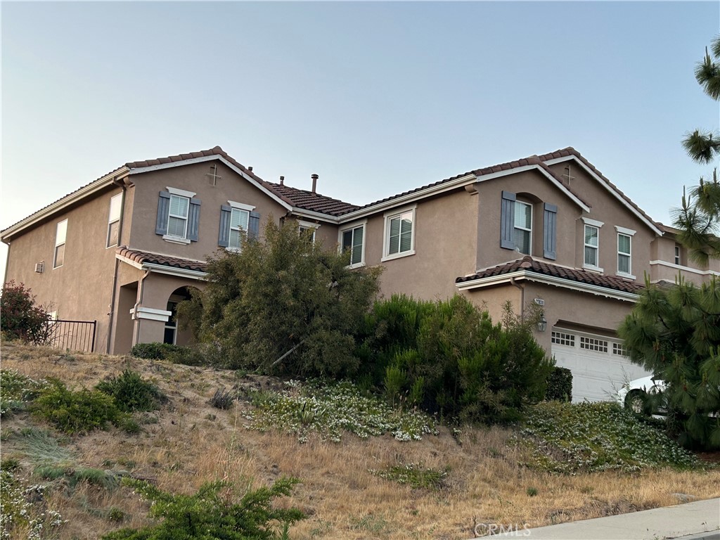 a house that has a lot of windows and trees in the background