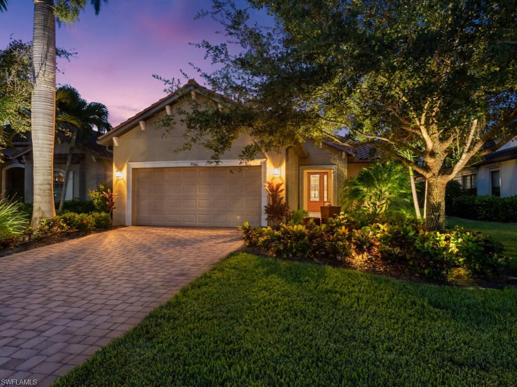 View of front of house with a landscape lighting.