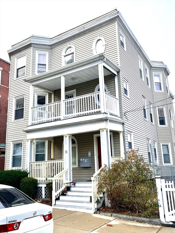 a front view of a residential apartment building with a yard