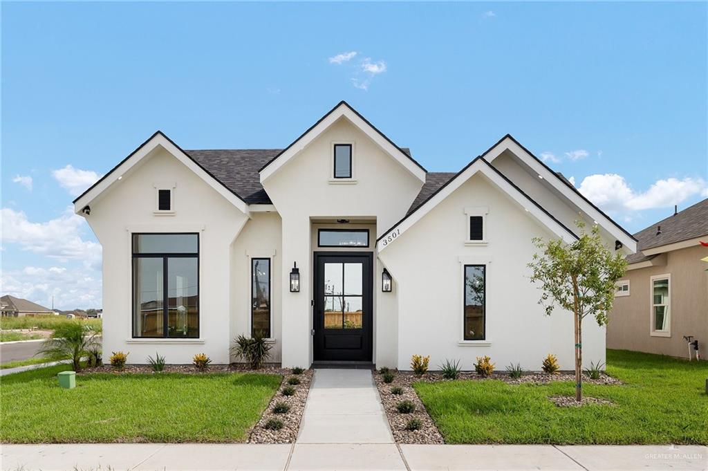 Modern inspired farmhouse with a front lawn