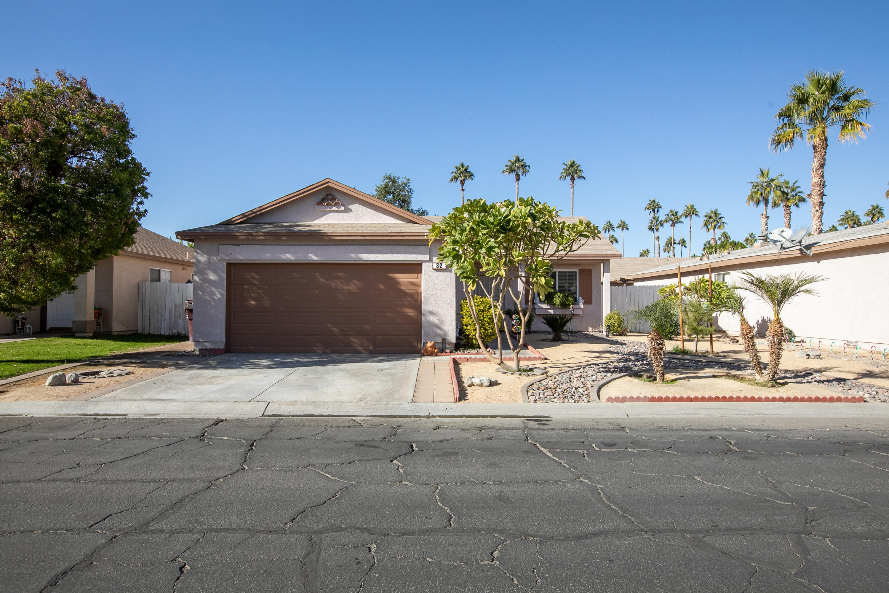 a view of a house with a patio and a yard