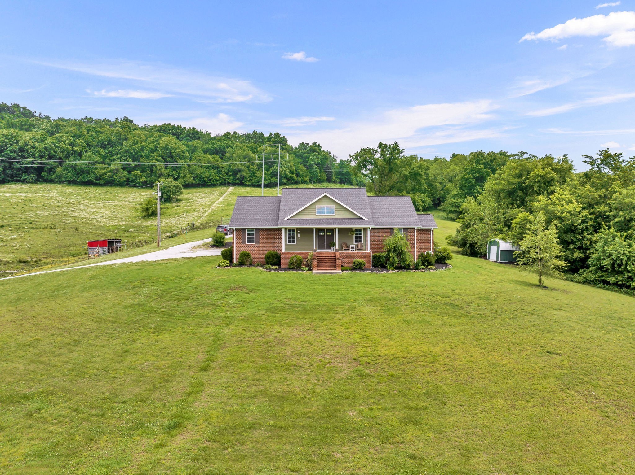 a aerial view of a house with pool and a yard