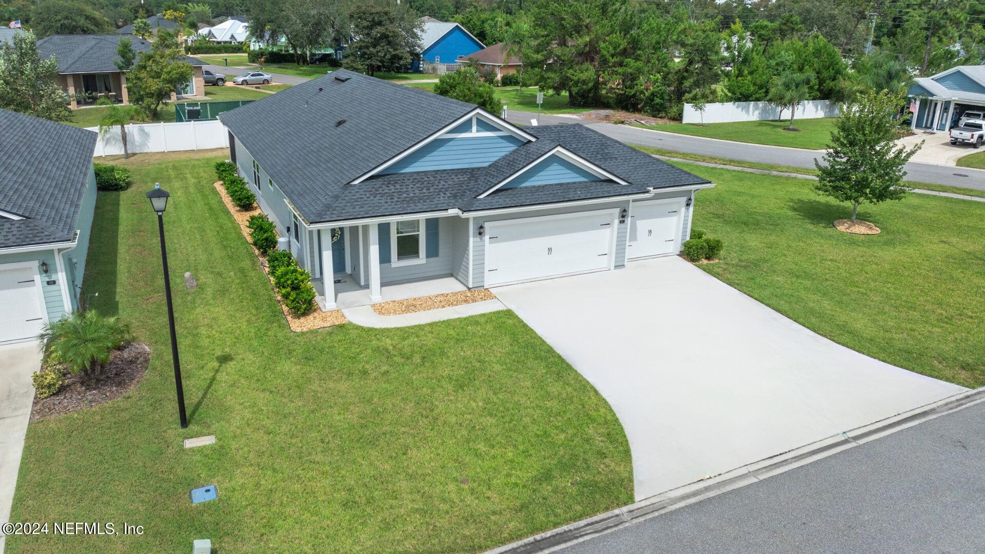 aerial view of a house with a yard