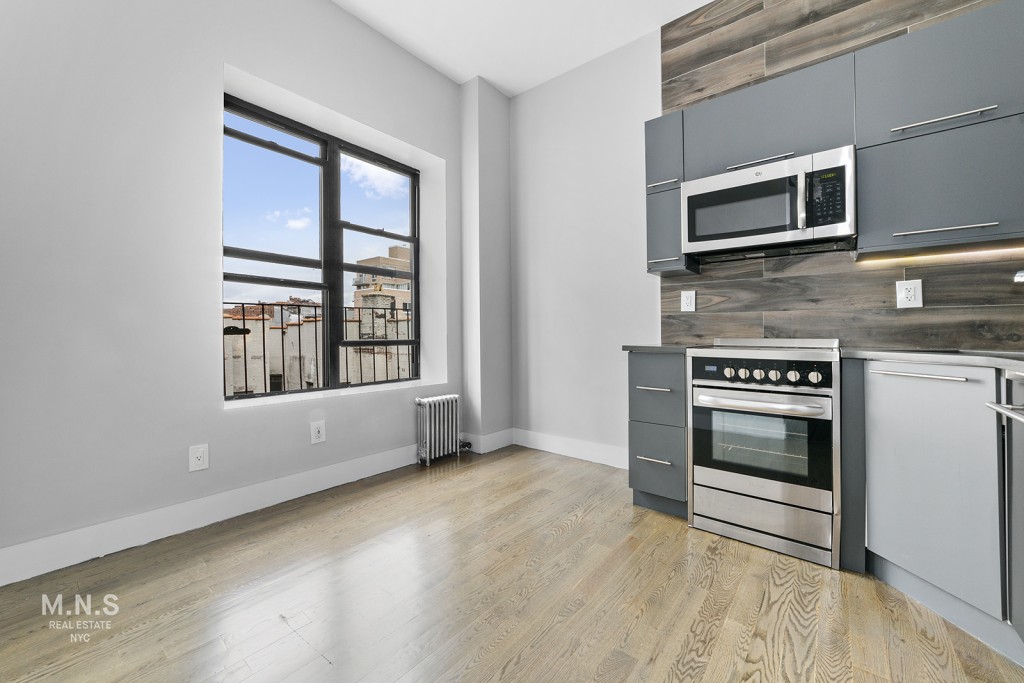 a kitchen with stainless steel appliances a stove and a microwave