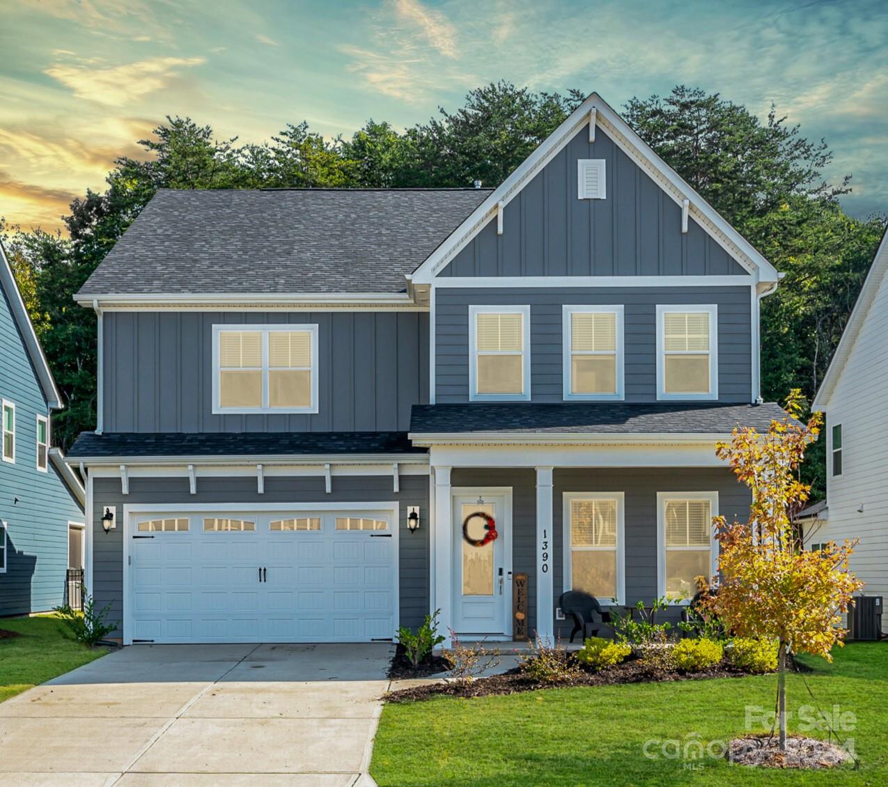 a front view of a house with a yard and garage