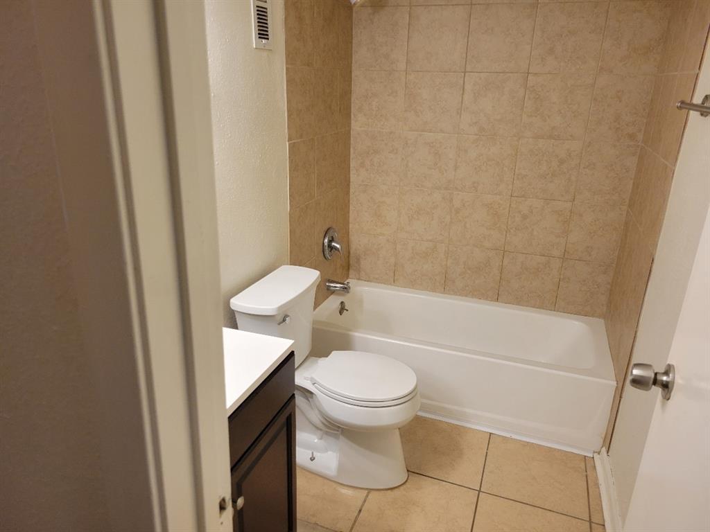 a white toilet sitting next to a bathtub