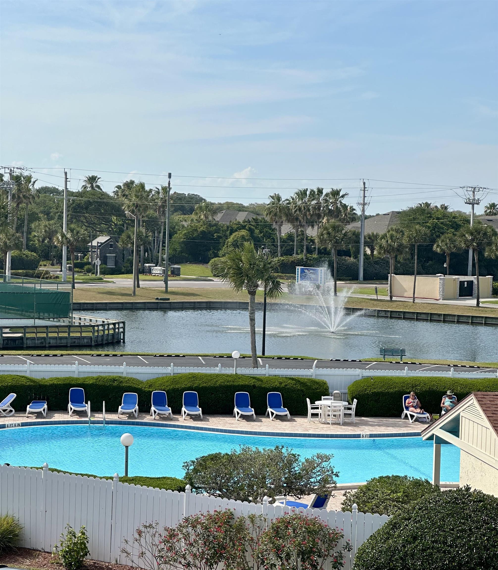 a view of a swimming pool next to a yard