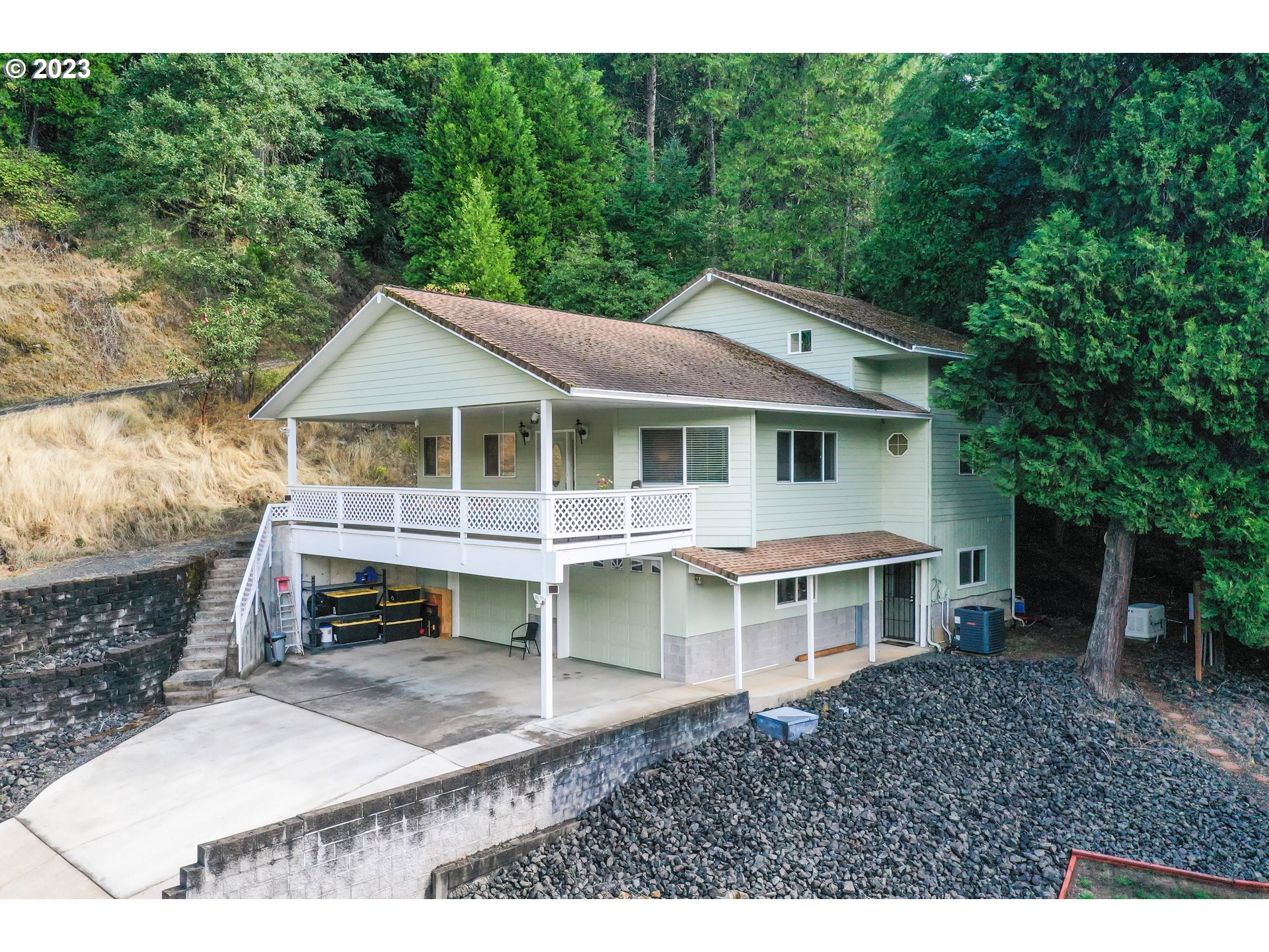 a view of a house with a yard balcony and sitting area