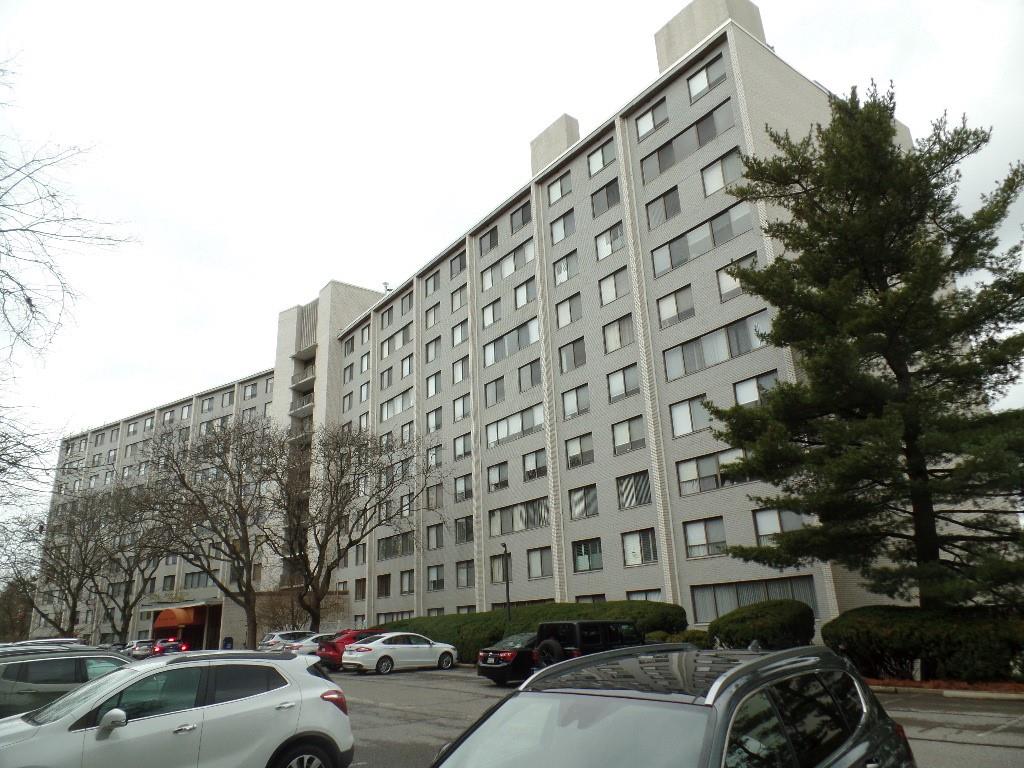 a couple of cars parked in front of a building