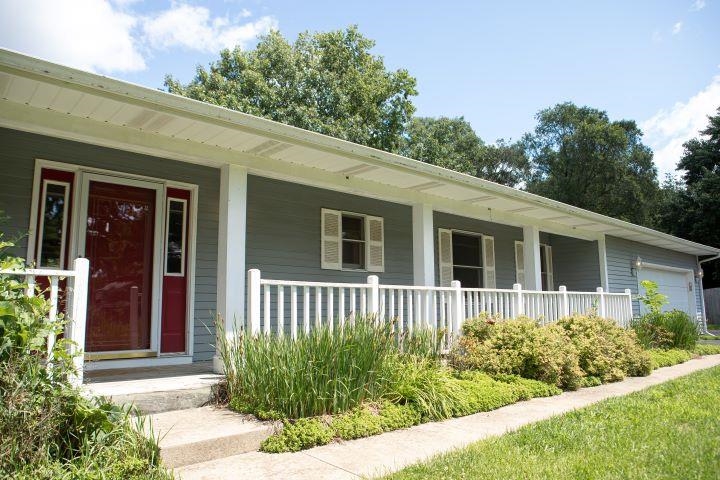 a front view of a house with garden