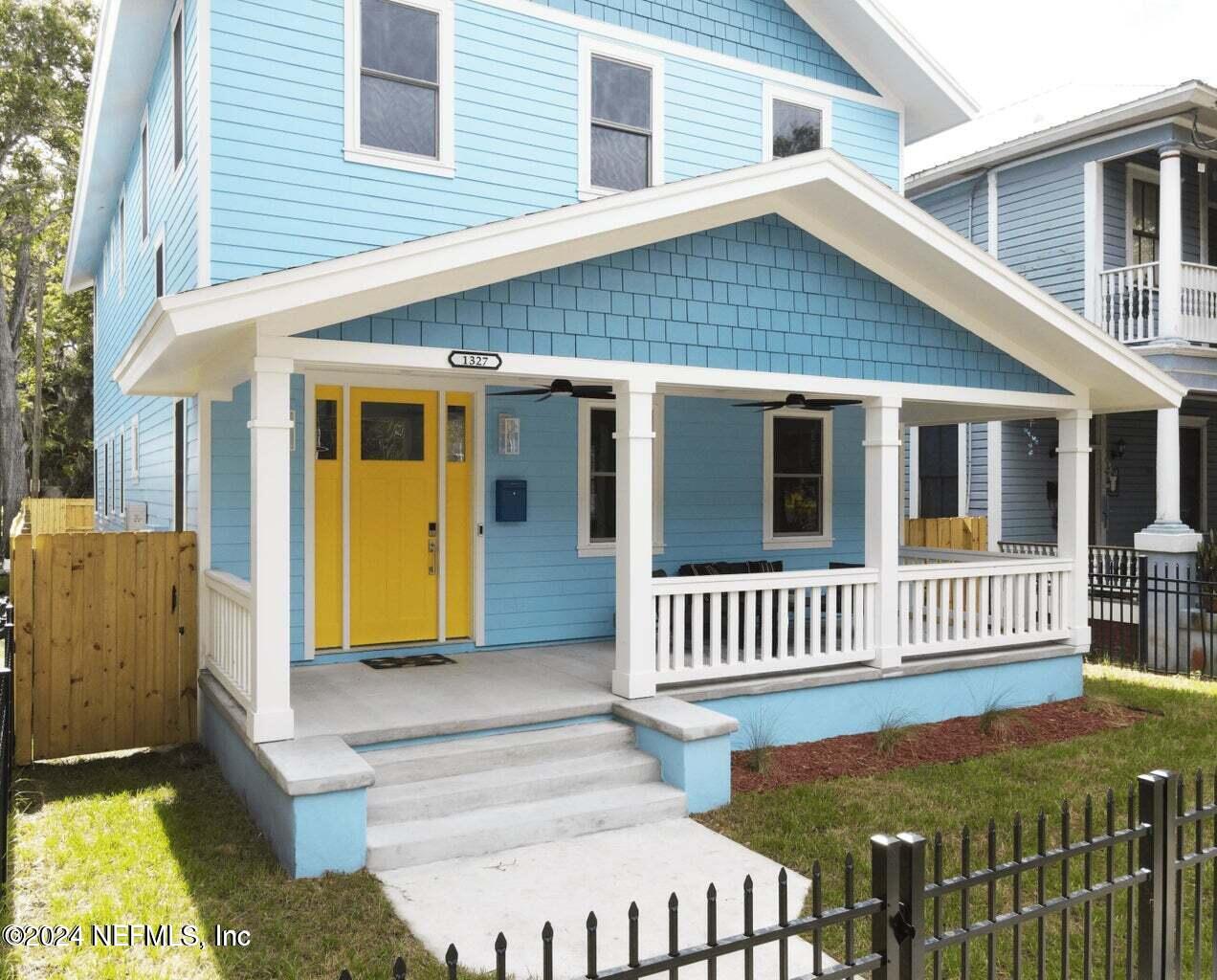 a view of a house with wooden fence