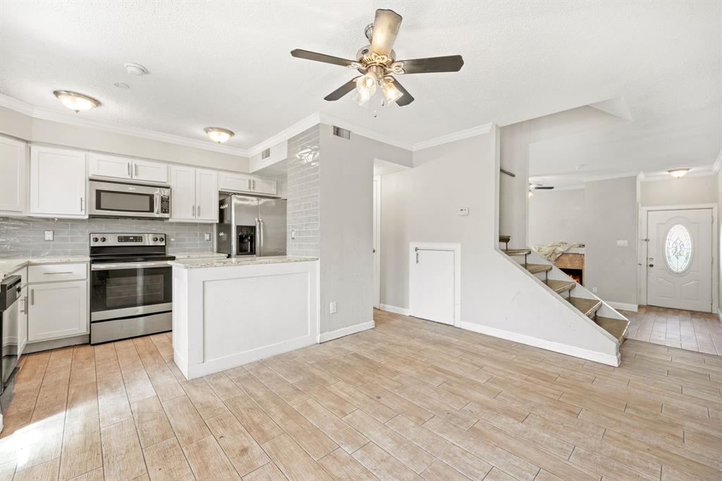 a view of kitchen with sink microwave and refrigerator