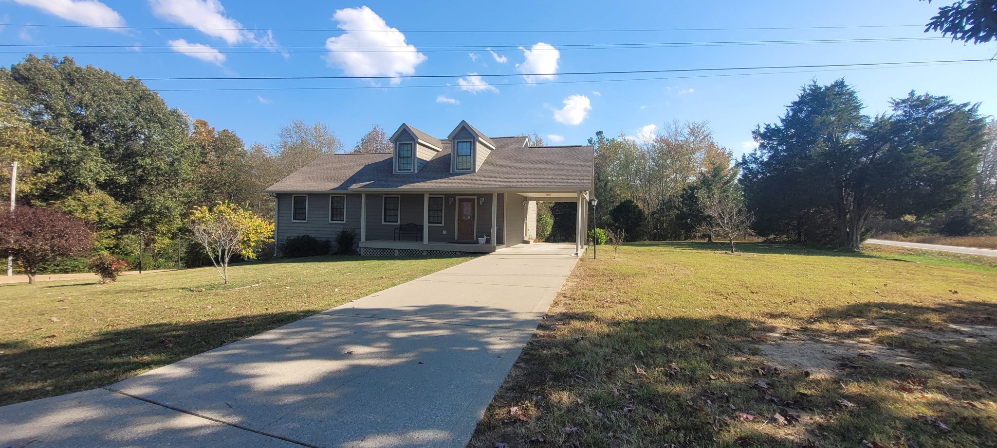 Cape Cod style home with carport . Level to sloped yard in quiet neighborhood.