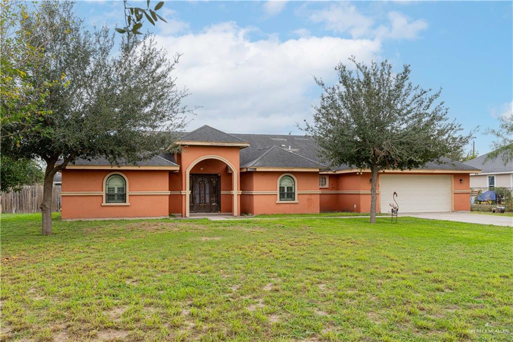 a big house with a big yard and large trees