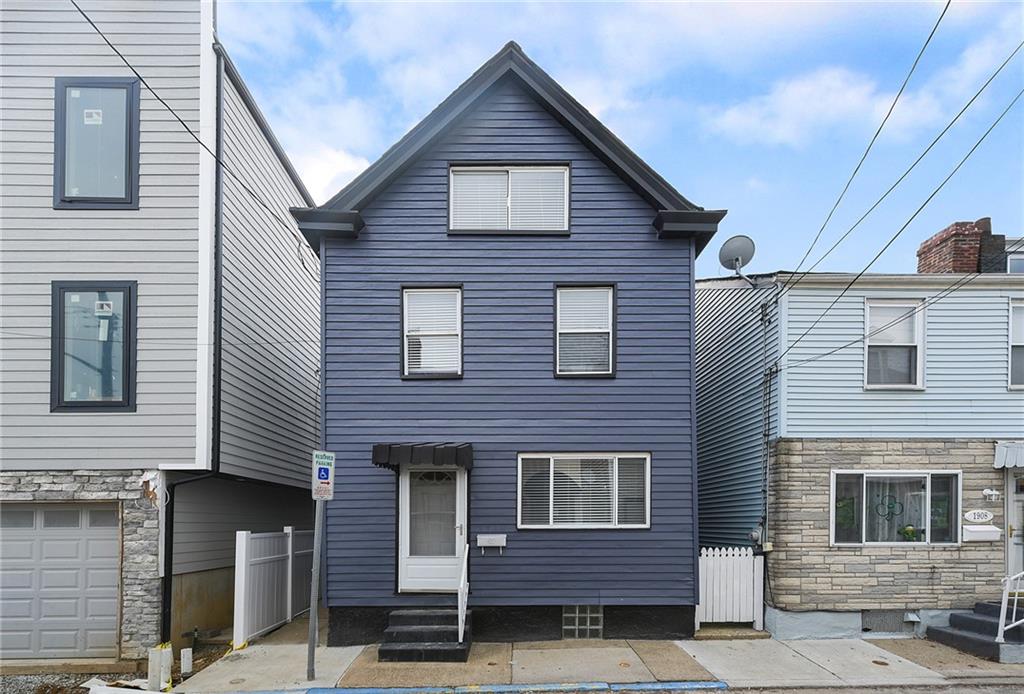 a view of a house with a door and wooden stairs