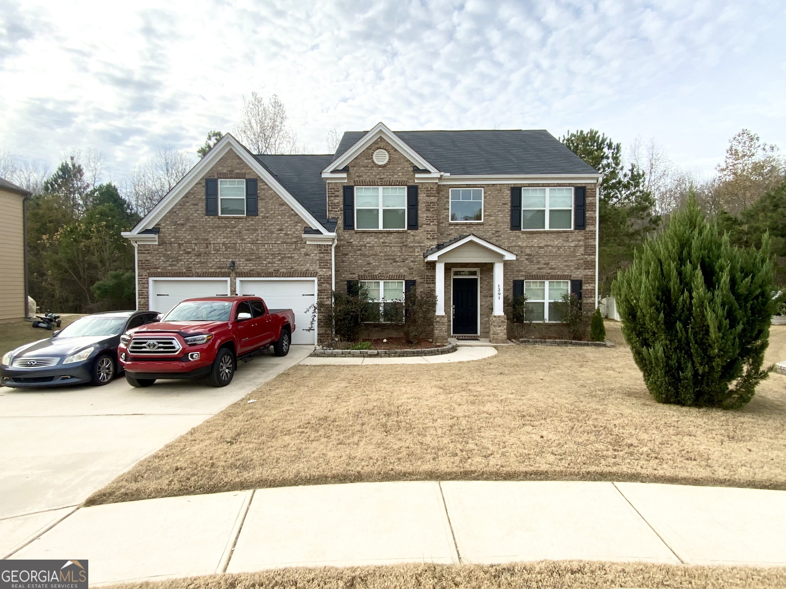 a front view of a house with a garden