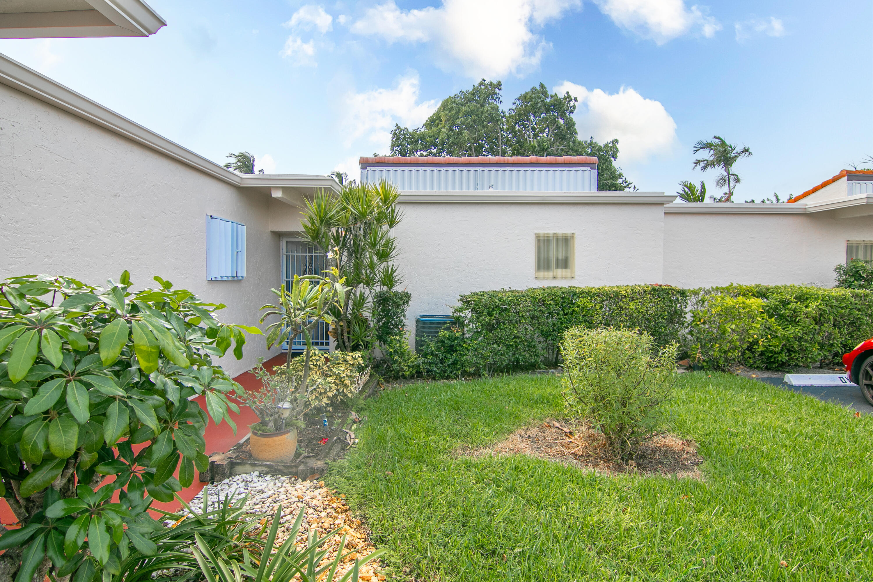 a view of a house with a yard and plants