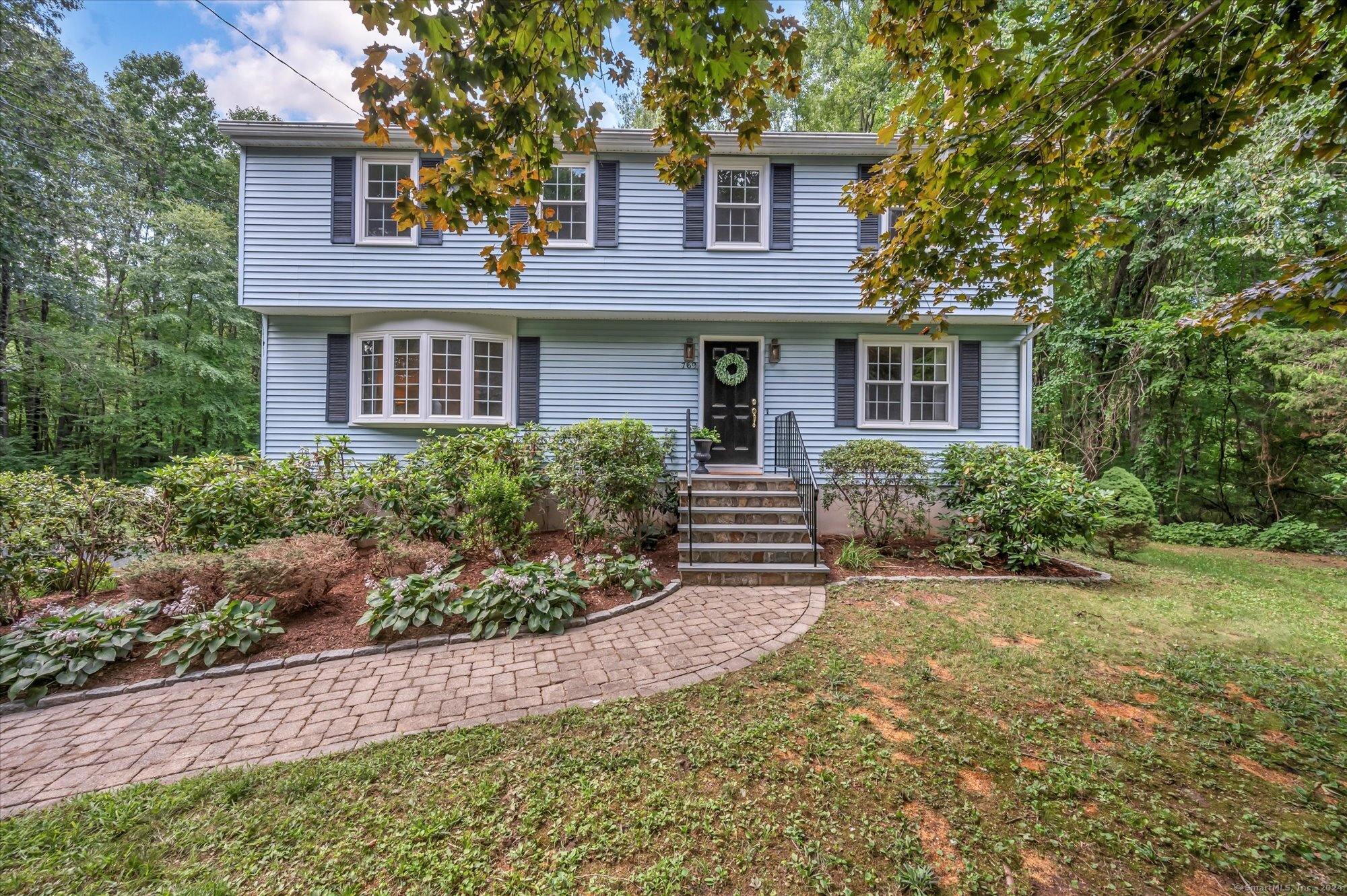 a front view of a house with garden