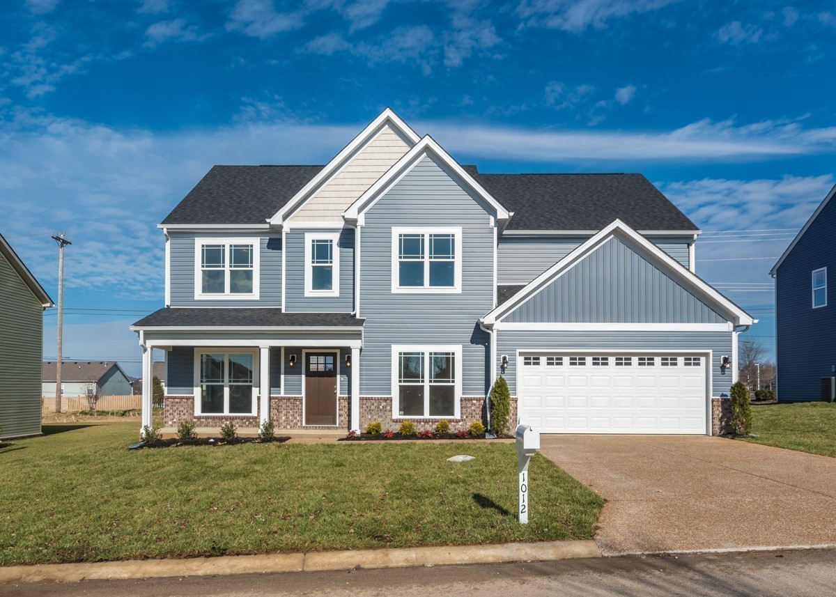 a front view of a house with a yard