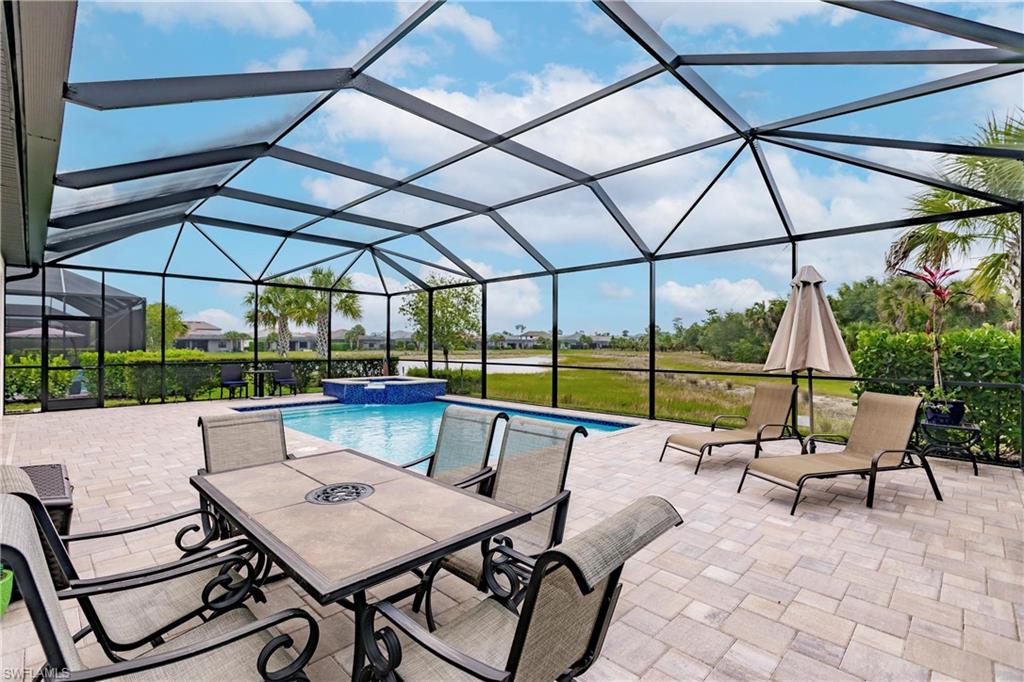 a view of patio with table and chairs under an umbrella