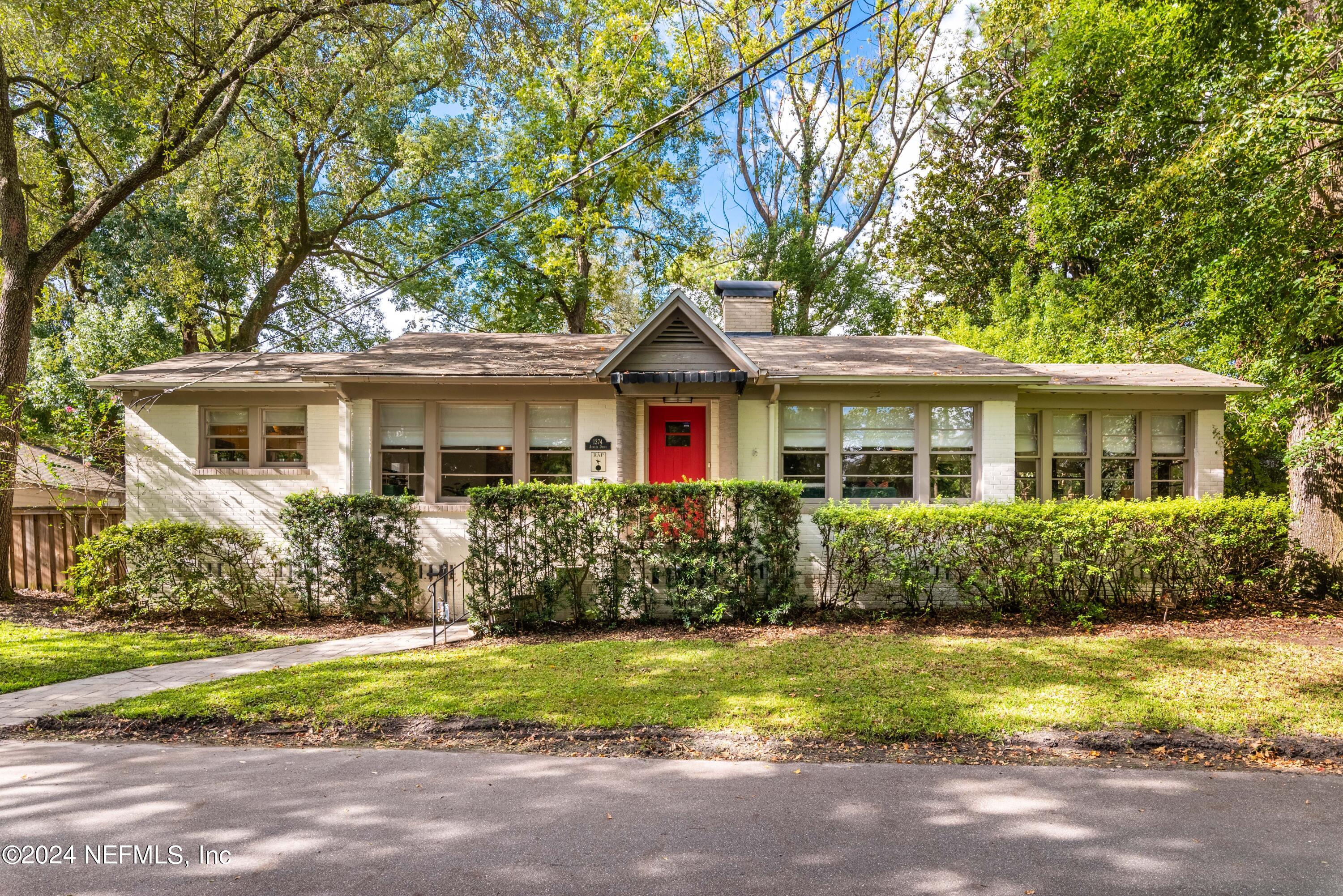 a front view of house with yard and green space