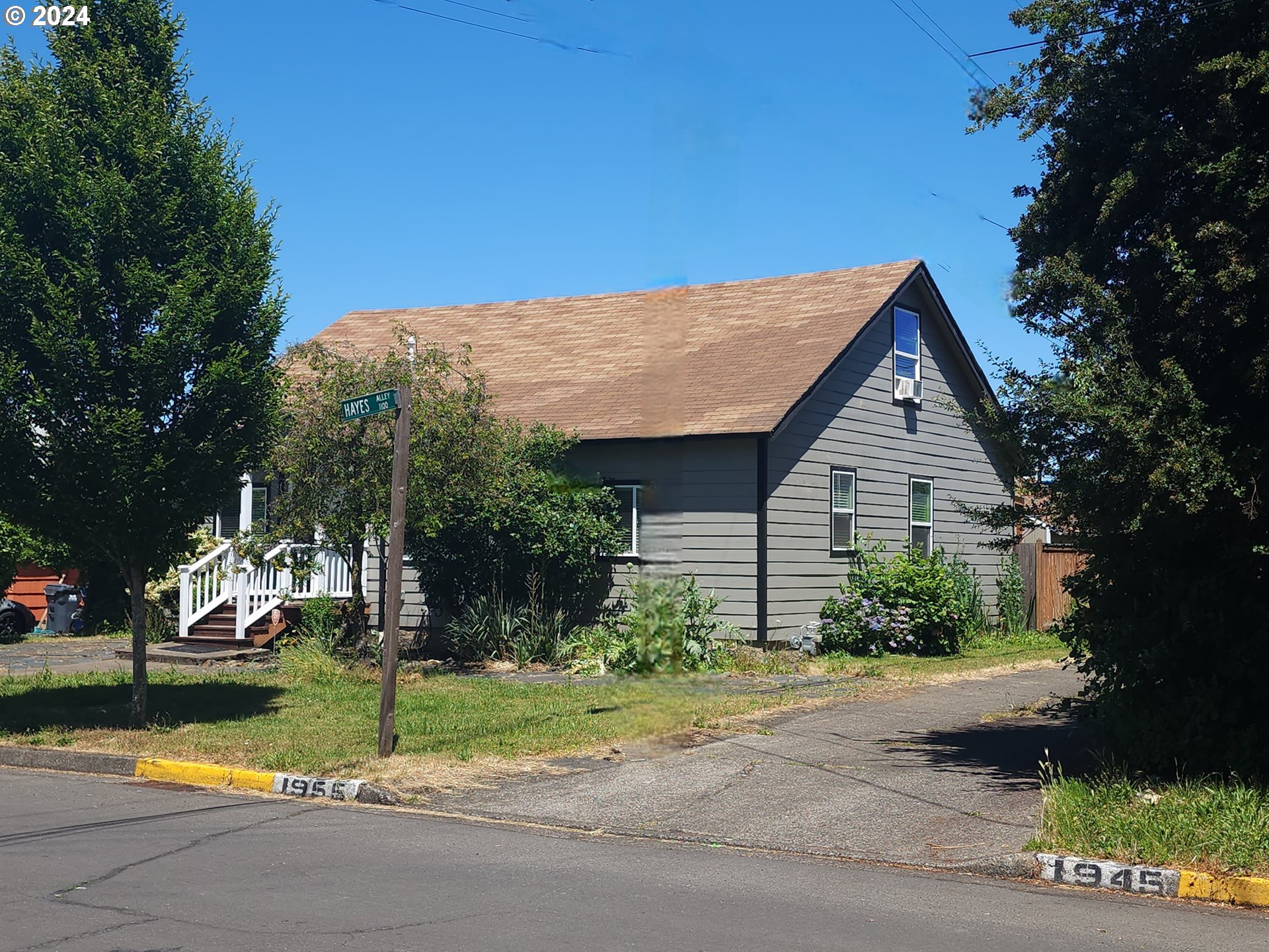 a view of backyard of house and car parked