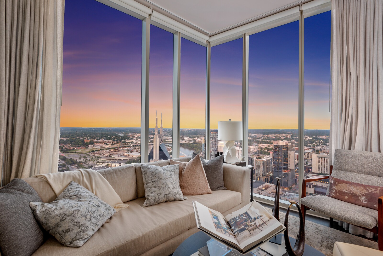 a living room with furniture and a floor to ceiling window