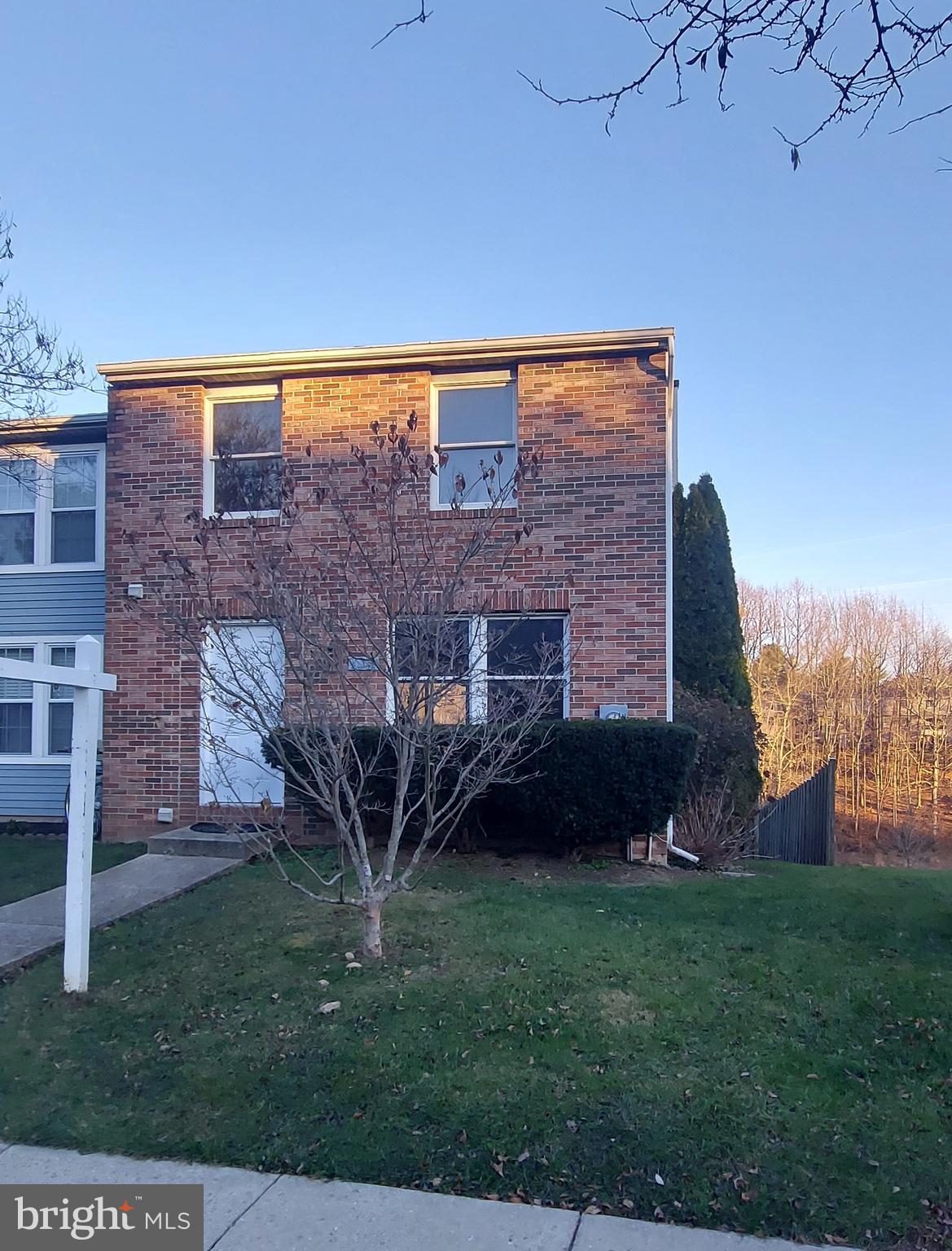 a view of a brick house with a yard