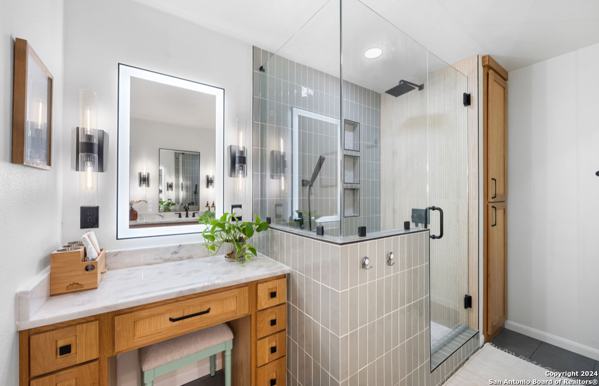 a bathroom with a double vanity sink and a mirror