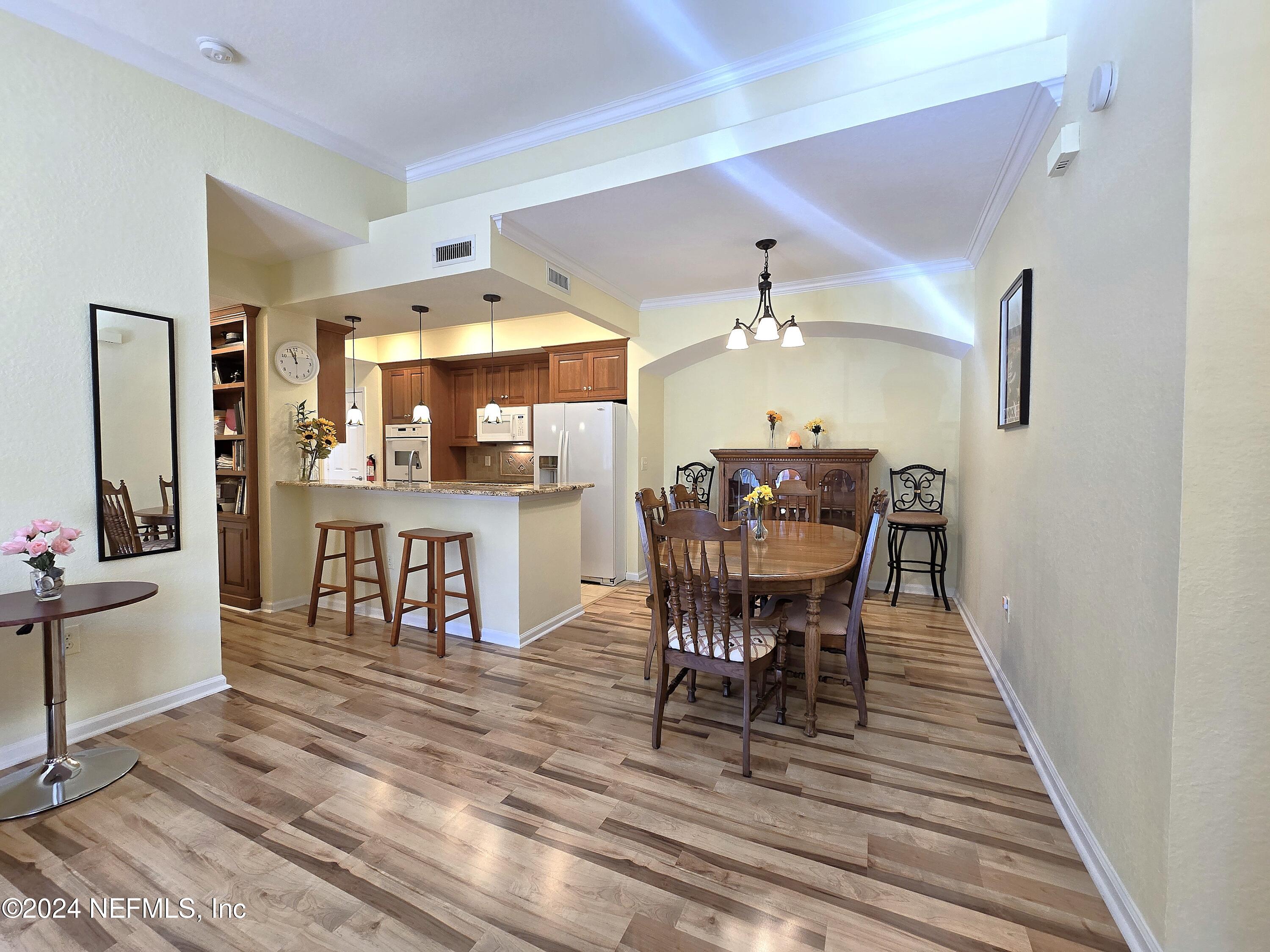 a view of a dining room with furniture and wooden floor