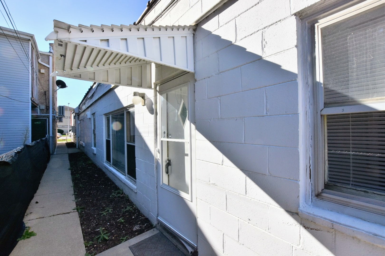 a view of staircase with railing and white walls