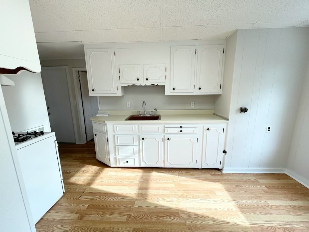 a view of a kitchen with white cabinets