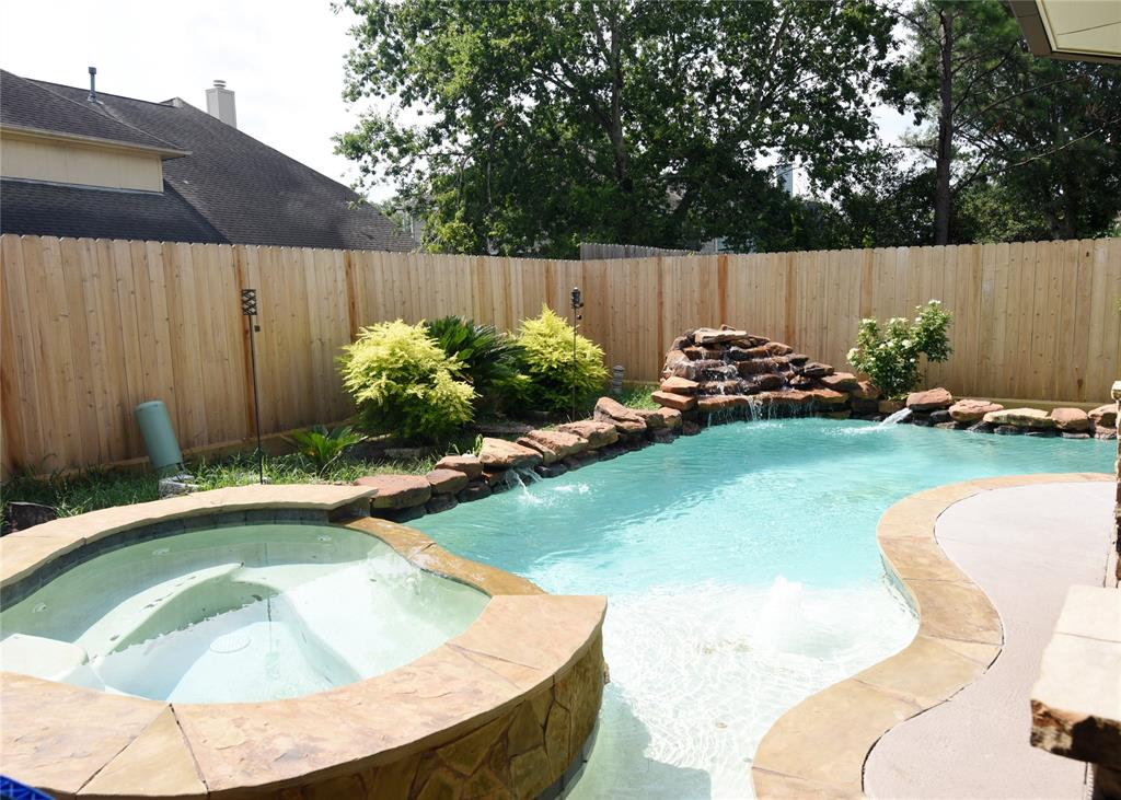 a view of a backyard with swimming pool