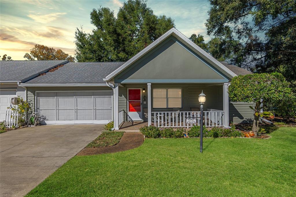 a front view of a house with a yard and porch